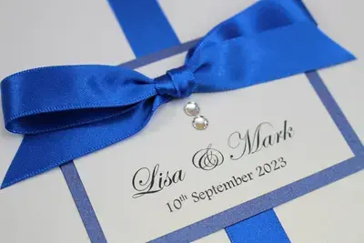 Affordable White and Royal Blue Wedding Invitation with Swarovski Crystals and a Tied Ribbon